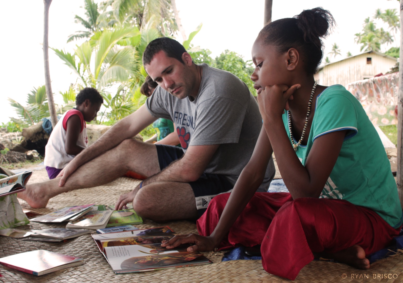 A student reads with a child.