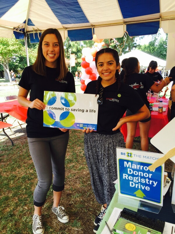 Two students hold a sign promoting bone marrow donation.