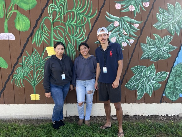 Students in front of garden mural.