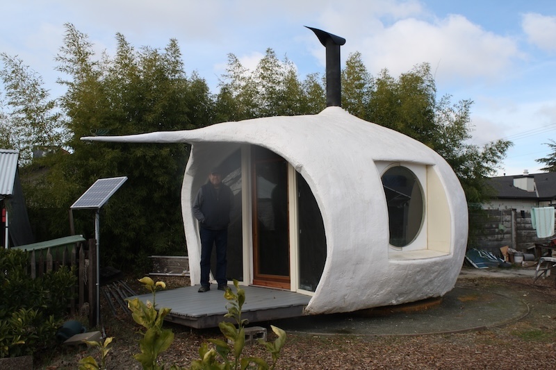 man standing in eco pod