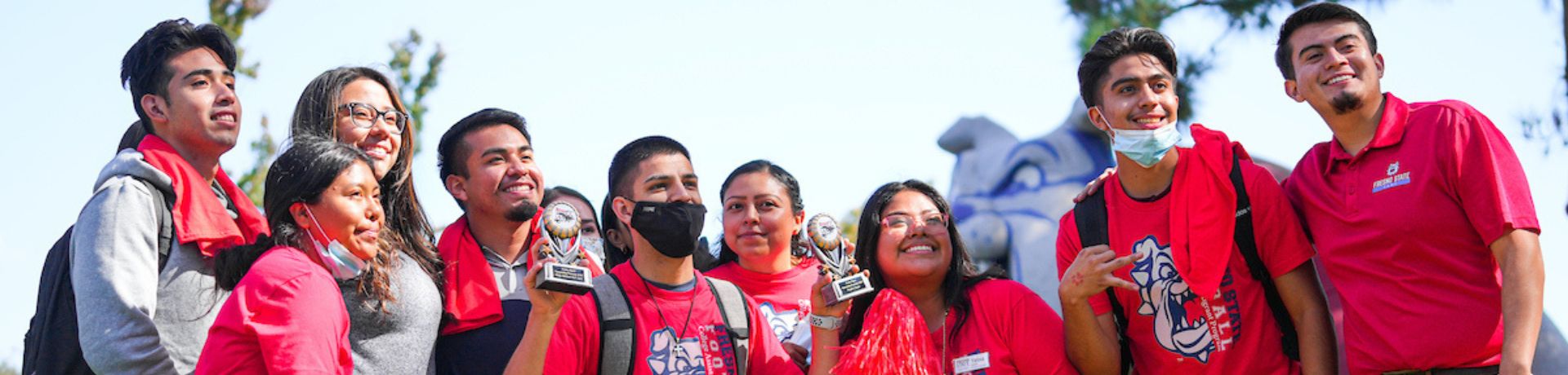 Group of students outside wearing Fresno State gear