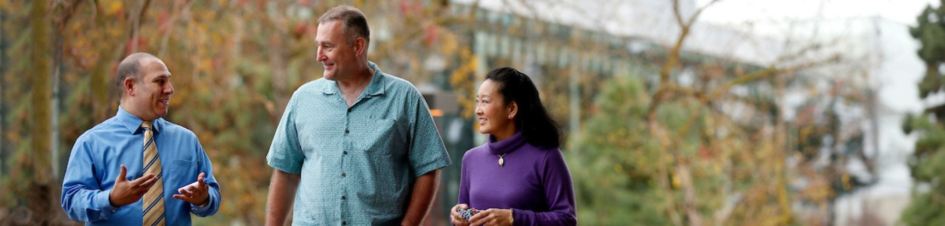 Faculty members walking on campus 