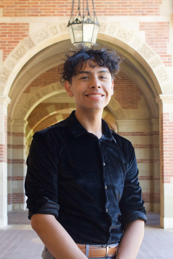 Andy Villarreal - head shot - in front of an arch of building