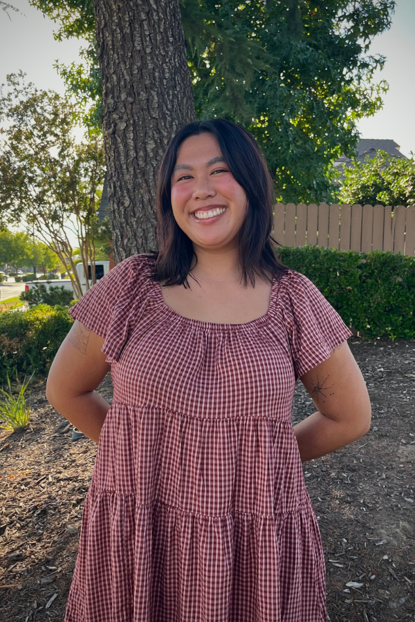 Outdoor photo of Tatiana in a red checked dress