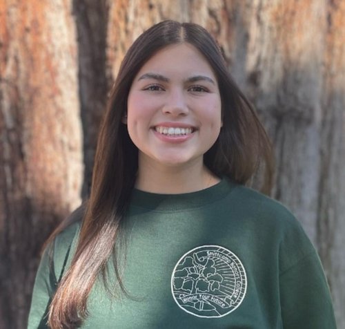 Mallory Sutherland wearing a green SFHC pullover.