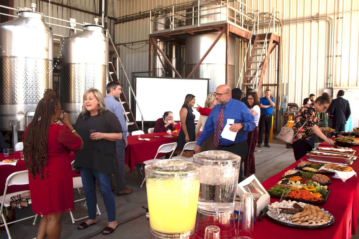 A gathering of faculty in the Fresno State winery