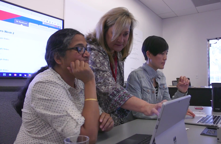 Instructional designer Mary Bennett assisting two faculty members