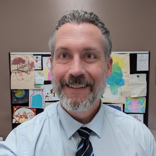 Headshot of Zach Justus in his office