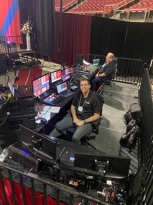 Eric West seated surrounded by video production equipment in the Save Mart Center at graduation