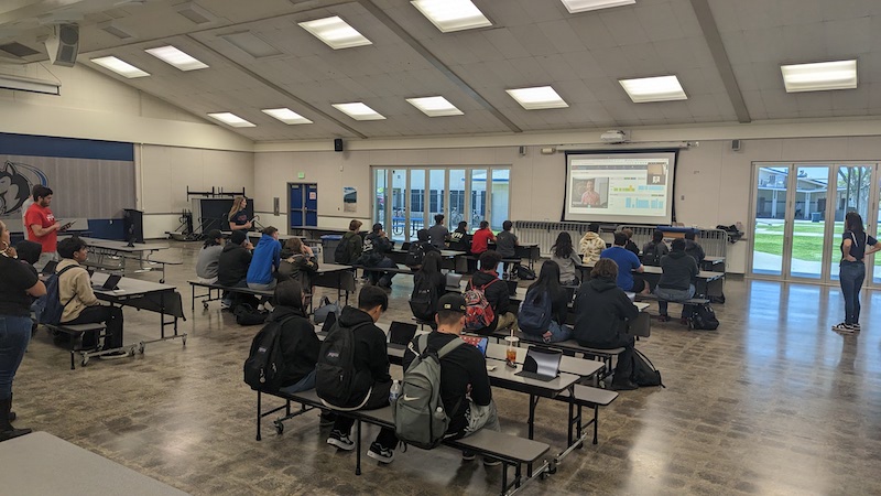 Clare Frederick giving a presentation to 30-40 students at the Hanford West High School cafeteria