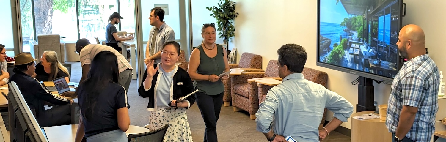 faculty members engaging in small groups in the lounge