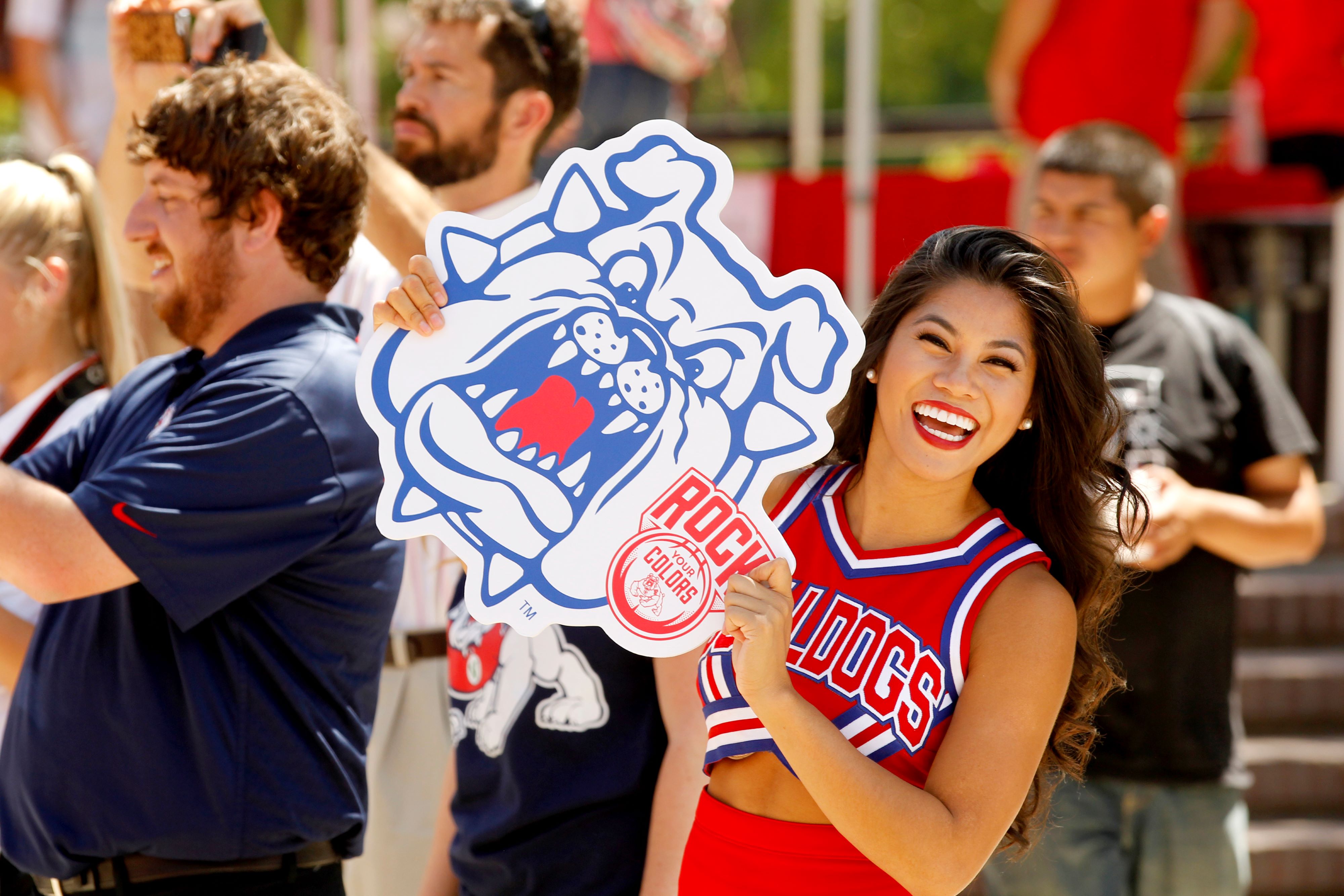 Cheerleader holding Bulldog cut-out