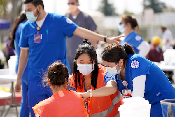 student nurses servicing the community with COVID vaccines